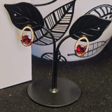 Oval earrings with garnet and diamond stone
